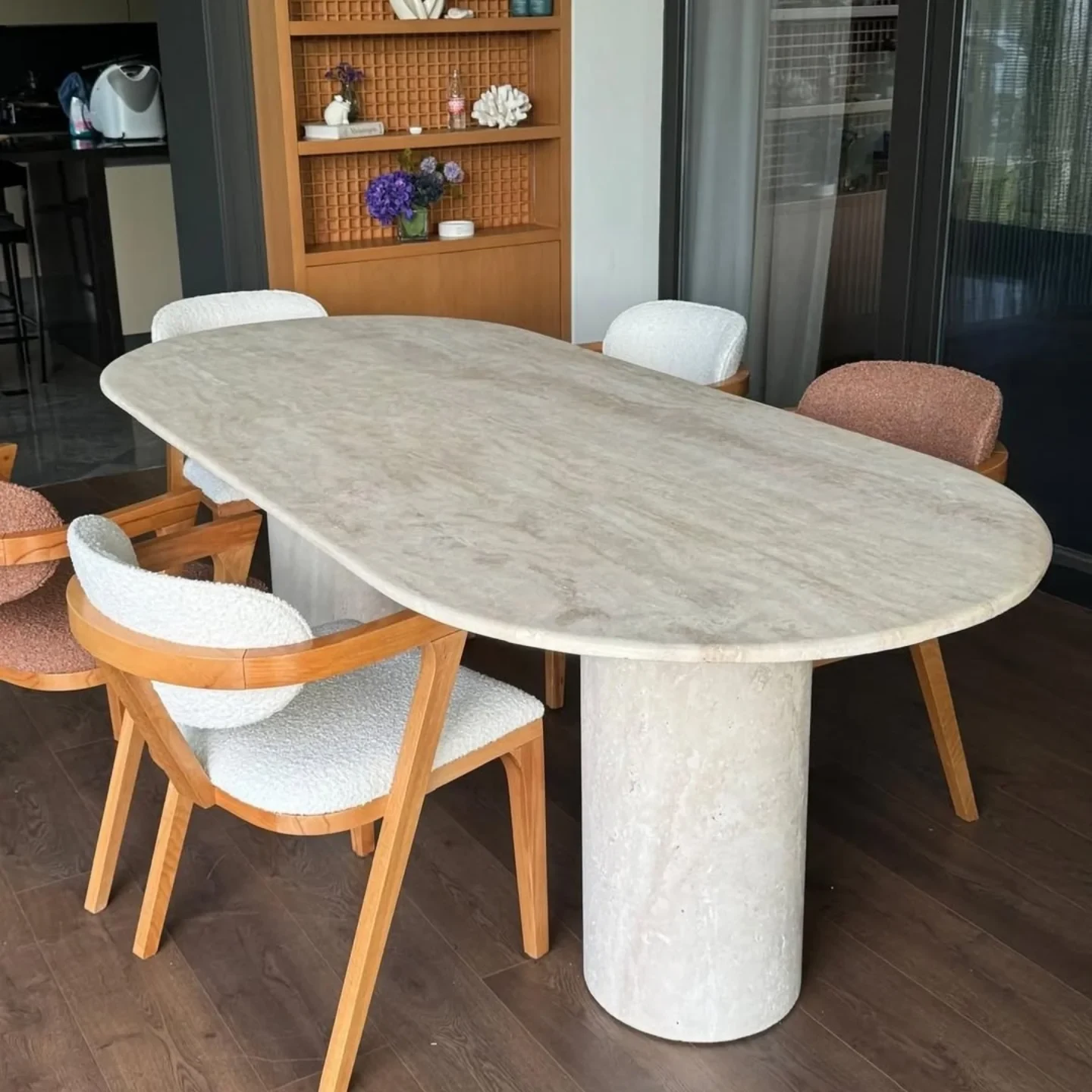 Perge Dining Table in Light Travertine: oval top with paired cylindrical supports